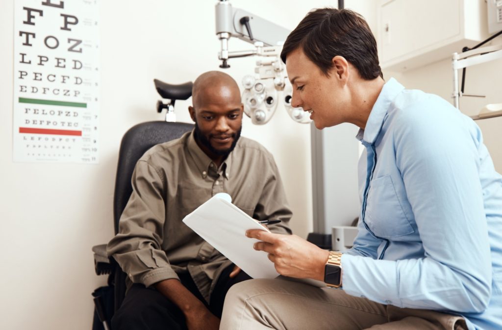 An optometrist explaining to a patient what's causing him to wake up with crusty eyelids after an eye exam.