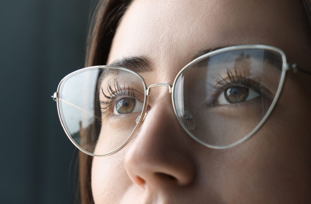 Close-up of someone's glasses as they look at a clear, distant landscape.