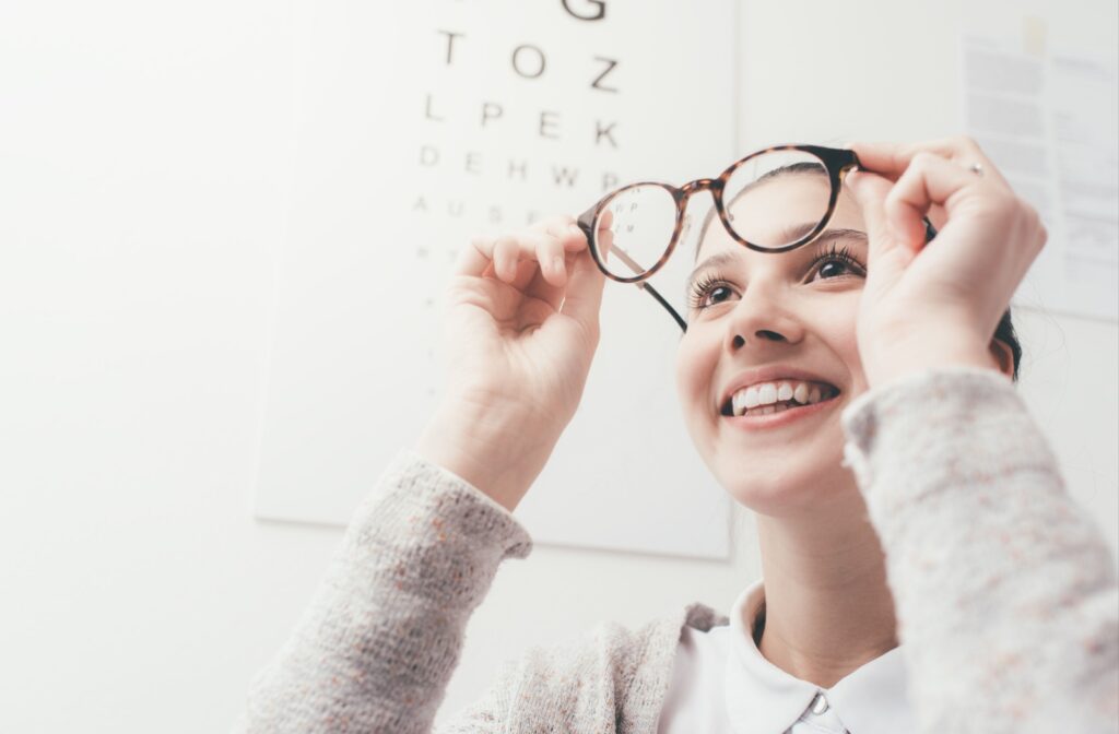 Someone tests their new glasses for nearsightedness during a comprehensive eye exam.